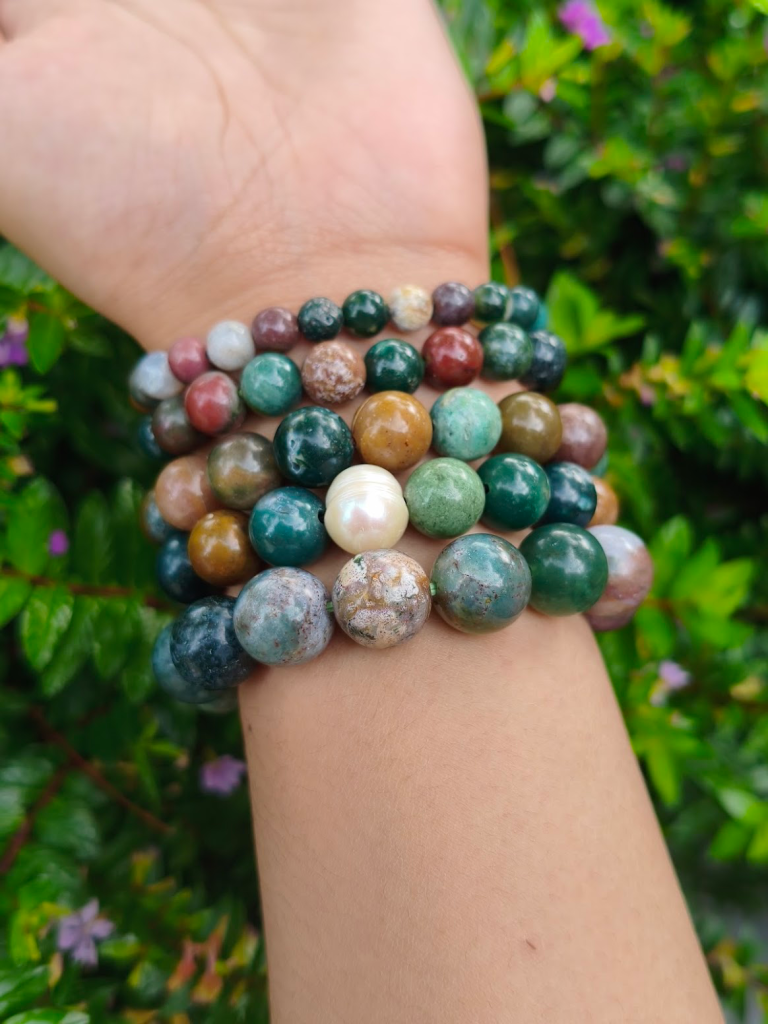 Madagascar Jasper round-bead bracelets worn together on a wrist outdoors.