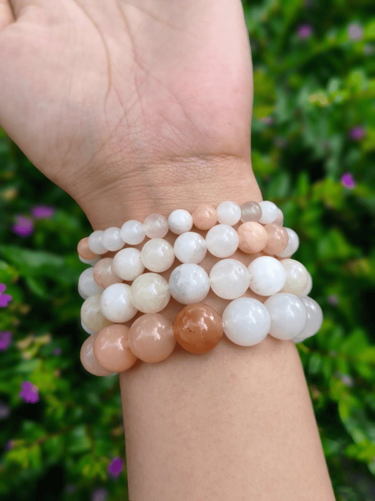 Shallow Pink Aventurine round-bead bracelets worn together on a wrist outdoors.