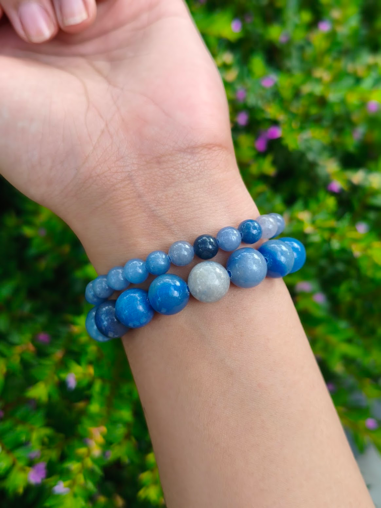 Blue Aventurine round-bead bracelets worn together on a wrist outdoors.
