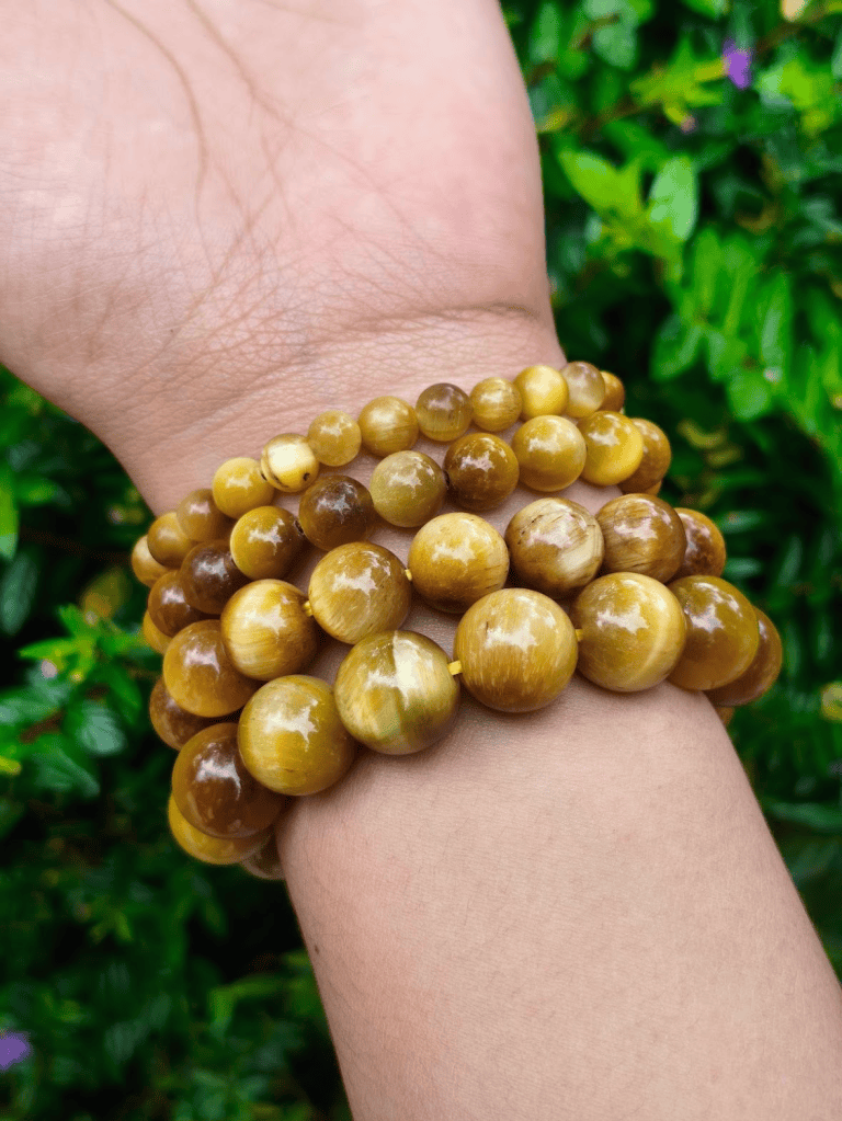 TÁWID Golden Tiger’s Eye round-bead bracelet worn on a wrist.