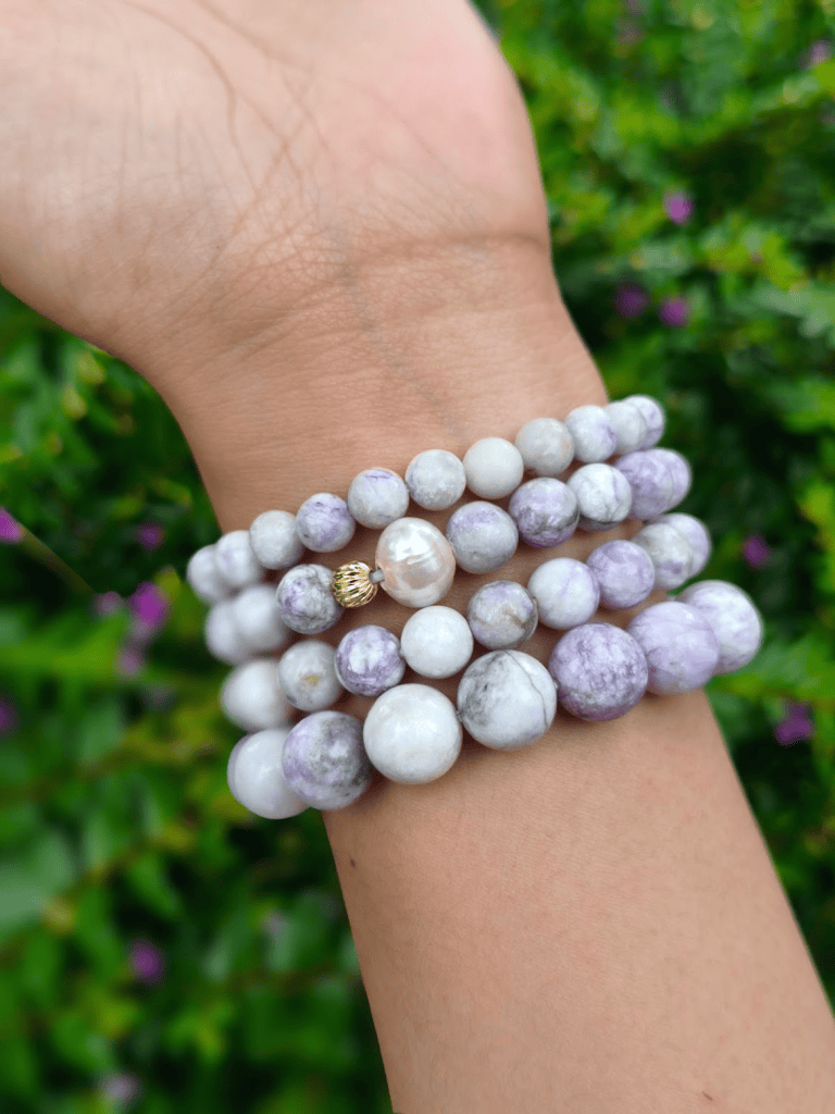 Tiffany Jasper round-bead bracelets worn together on a wrist outdoors.